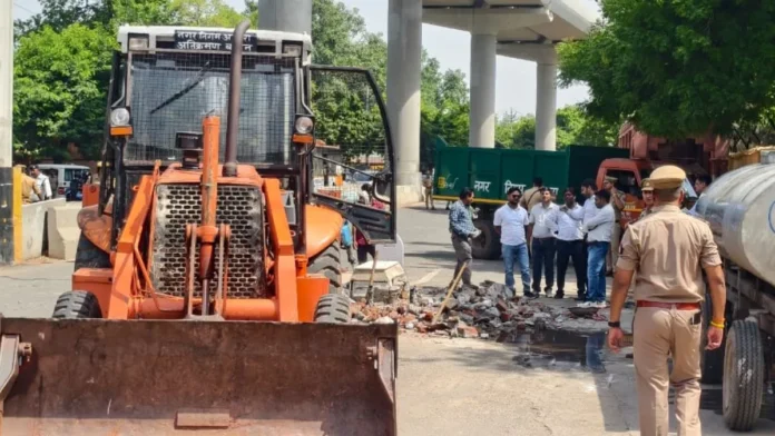 Bulldozer action on Agra's MG Road sparks a stir; alleged illegal shrine on the roadside removed, citing traffic improvement